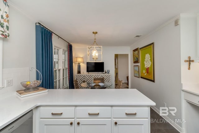 6000 Shenandoah Rd, Mobile, AL 36608 - kitchen featuring a peninsula, stainless steel dishwasher, light countertops, white cabinets, and hanging light fixtures