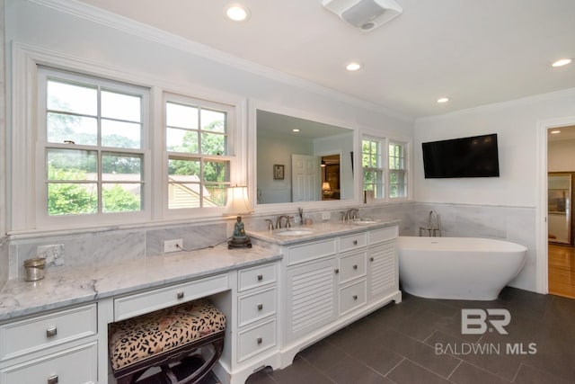6000 Shenandoah Rd, Mobile, AL 36608 - bathroom featuring tile walls, tile patterned flooring, recessed lighting, a freestanding bath, and vanity