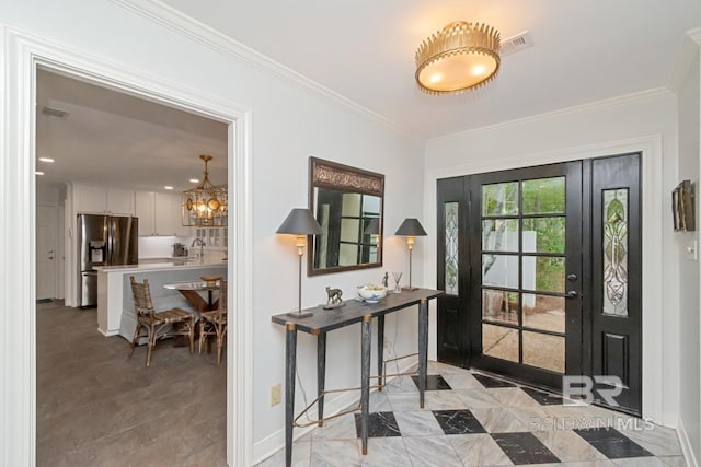 6000 Shenandoah Rd, Mobile, AL 36608 - foyer featuring a chandelier, baseboards, and ornamental molding