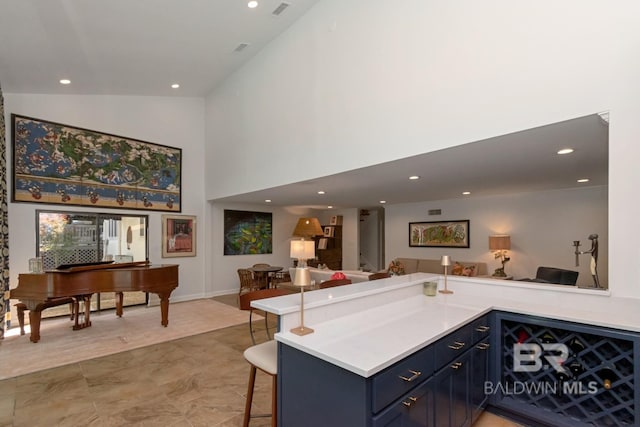 6000 Shenandoah Rd, Mobile, AL 36608 - kitchen with open floor plan, light countertops, high vaulted ceiling, a kitchen breakfast bar, and recessed lighting