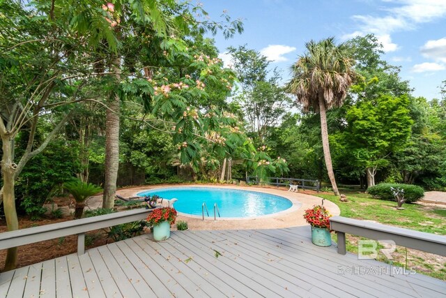 6000 Shenandoah Rd, Mobile, AL 36608 - swimming pool with a wooden deck and view of scattered trees