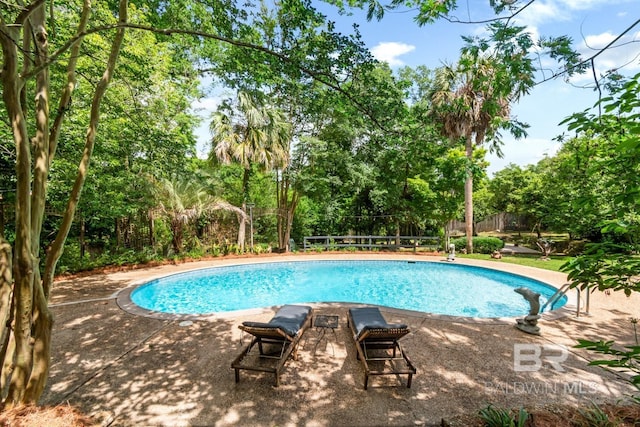 6000 Shenandoah Rd, Mobile, AL 36608 - view of swimming pool with view of scattered trees and fence