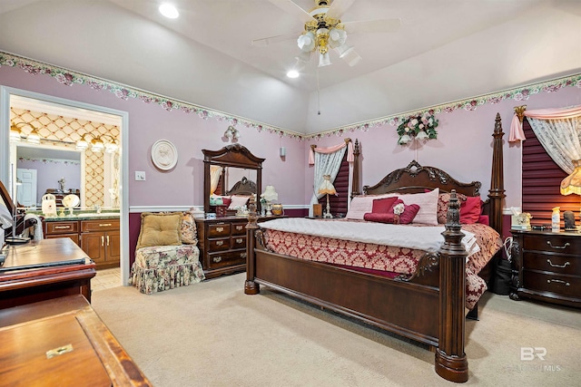 carpeted bedroom featuring ensuite bath, ceiling fan, and vaulted ceiling