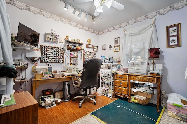 home office featuring track lighting, ceiling fan, and wood-type flooring