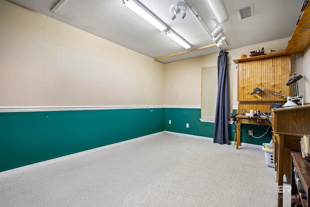 interior space with a workshop area and carpet floors