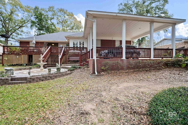 rear view of property featuring a deck