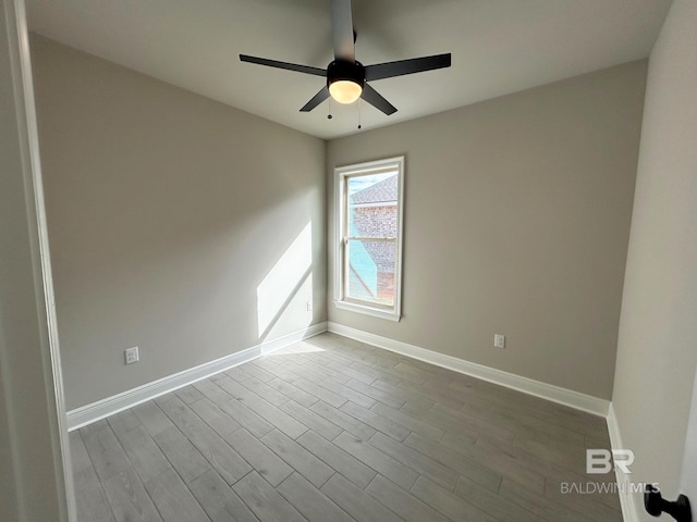 empty room featuring ceiling fan and light hardwood / wood-style flooring