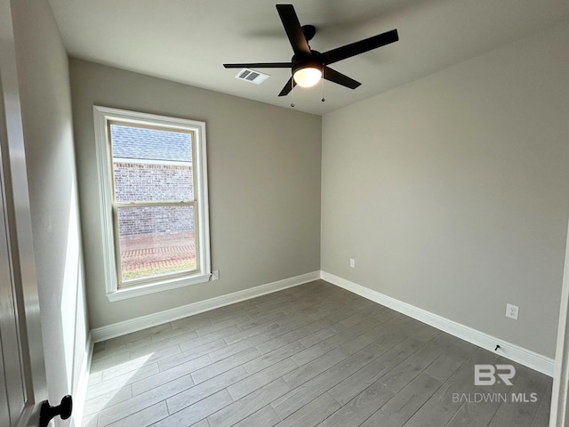 spare room with hardwood / wood-style flooring, plenty of natural light, and ceiling fan