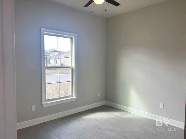 empty room featuring light wood-type flooring and ceiling fan