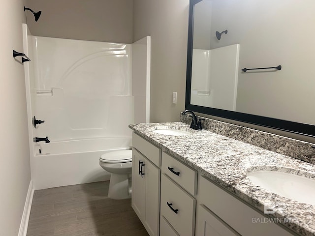 full bathroom featuring hardwood / wood-style floors, vanity, toilet, and washtub / shower combination