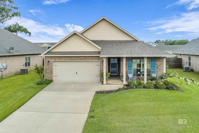 1556 Kairos Loop, Foley, AL 36535 - view of front of house featuring covered porch, brick siding, a shingled roof, and a garage