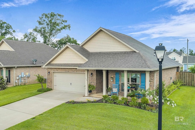 1556 Kairos Loop, Foley, AL 36535 - view of front facade with covered porch, an attached garage, brick siding, driveway, and roof with shingles