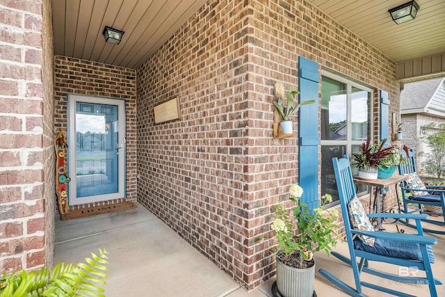 1556 Kairos Loop, Foley, AL 36535 - doorway to property featuring brick siding and a porch