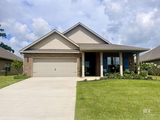 1556 Kairos Loop, Foley, AL 36535 - view of front of house with a front lawn, driveway, brick siding, and an attached garage