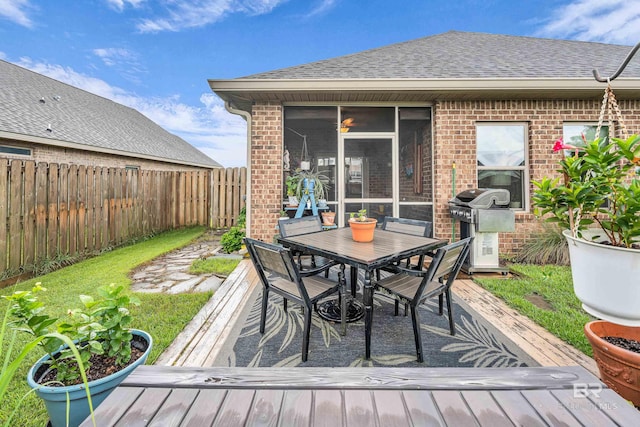 1556 Kairos Loop, Foley, AL 36535 - wooden terrace featuring area for grilling, a fenced backyard, outdoor dining area, and a sunroom