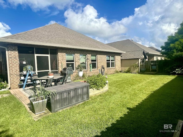 1556 Kairos Loop, Foley, AL 36535 - back of property with brick siding, a lawn, and a shingled roof