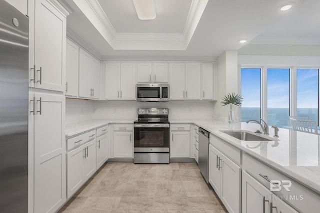 23008 W Perdido Beach Blvd Unit 1905, Orange Beach, AL 36561 - kitchen with stainless steel appliances, a sink, a raised ceiling, white cabinets, and light stone countertops