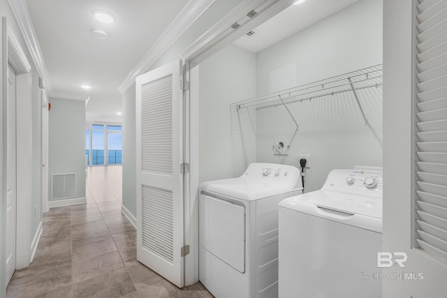 23008 W Perdido Beach Blvd Unit 1905, Orange Beach, AL 36561 - laundry area with independent washer and dryer, crown molding, and baseboards