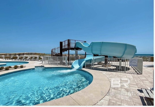 23008 W Perdido Beach Blvd Unit 1905, Orange Beach, AL 36561 - community pool featuring a water slide, fence, and a patio area