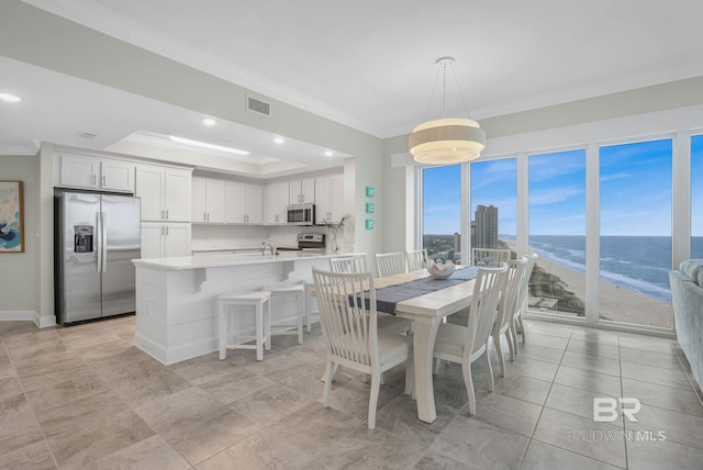 23008 W Perdido Beach Blvd Unit 1905, Orange Beach, AL 36561 - dining room with crown molding, a water view, baseboards, recessed lighting, and a tray ceiling