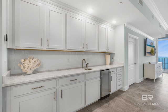 23008 W Perdido Beach Blvd Unit 1905, Orange Beach, AL 36561 - kitchen with tasteful backsplash, ornamental molding, refrigerator, a sink, and white cabinets