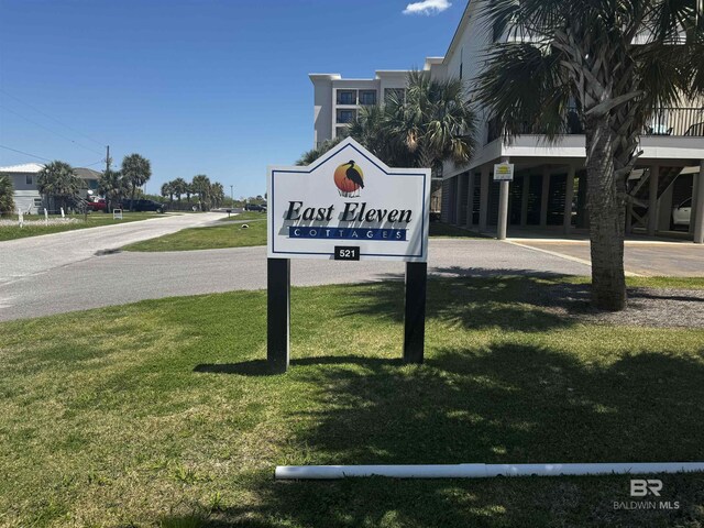 community sign featuring a lawn
