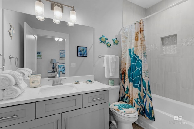 bathroom featuring toilet, shower / bathtub combination with curtain, and vanity