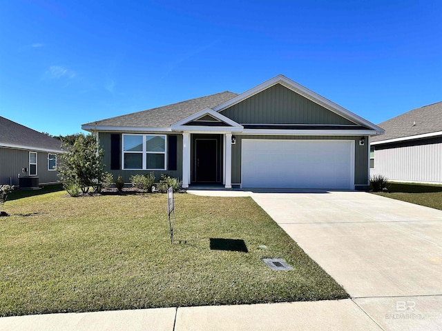 view of front facade with a garage, central AC, and a front lawn