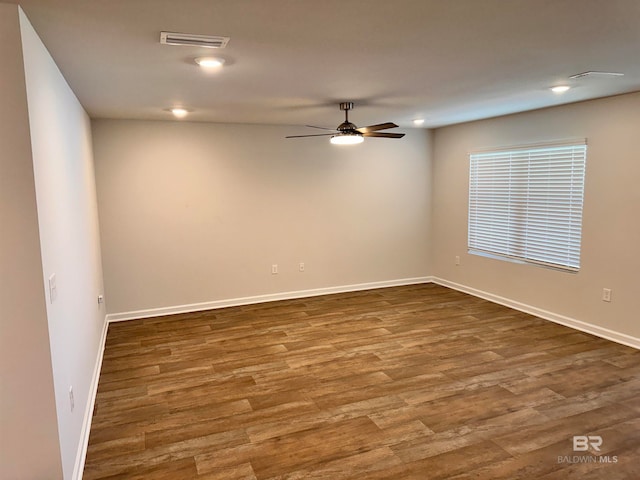 spare room featuring hardwood / wood-style flooring and ceiling fan