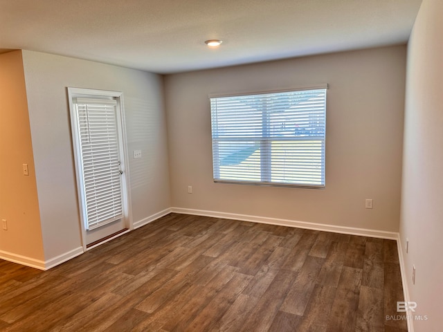 unfurnished bedroom with dark wood-type flooring