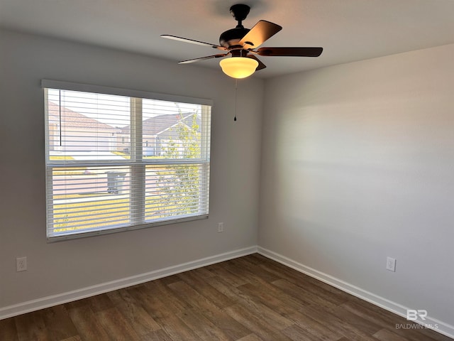 spare room with ceiling fan and dark wood-type flooring