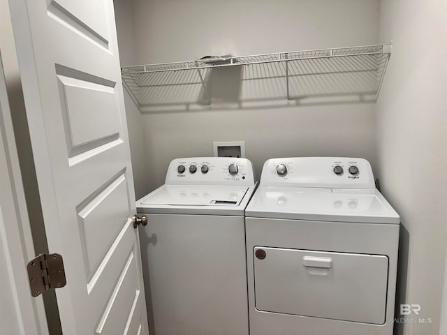 clothes washing area featuring washer and dryer