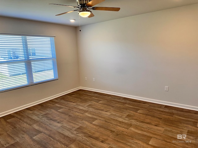 unfurnished room with dark hardwood / wood-style floors and ceiling fan