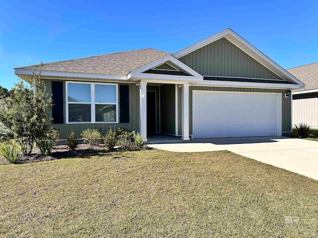 view of front of house featuring a front yard and a garage