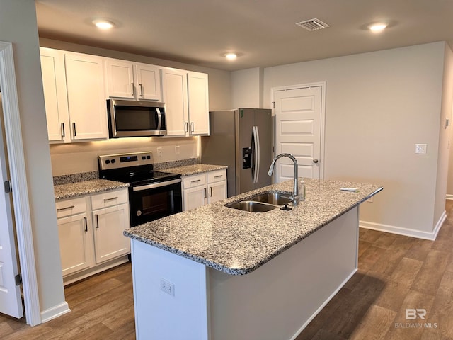 kitchen featuring white cabinets, an island with sink, stainless steel appliances, and sink