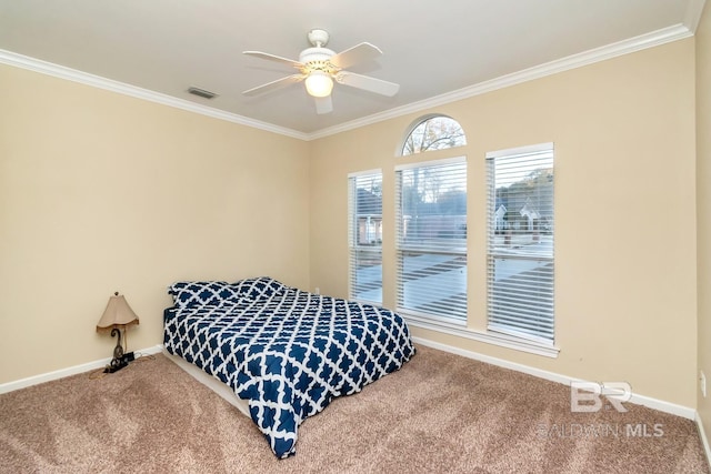 carpeted bedroom featuring ornamental molding and ceiling fan