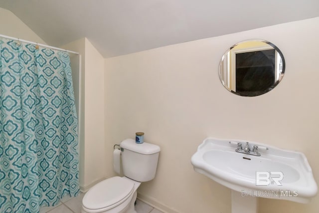 bathroom with tile patterned flooring and toilet