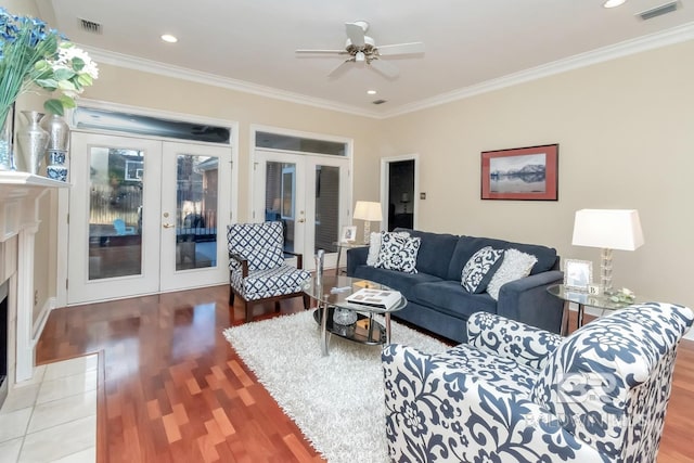 living room with ornamental molding, hardwood / wood-style floors, ceiling fan, and french doors