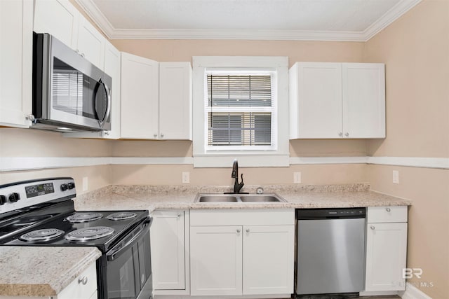 kitchen featuring a sink, light countertops, appliances with stainless steel finishes, white cabinetry, and ornamental molding