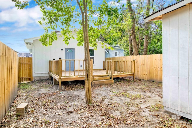 wooden terrace with a fenced backyard
