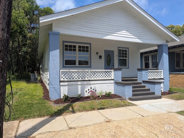 bungalow with central air condition unit and a porch