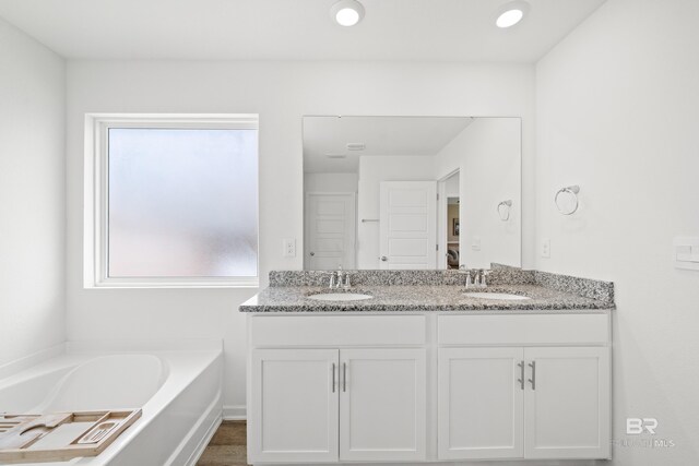 14705 Forsythia Loop, Silverhill, AL 36576 - full bathroom with double vanity and a garden tub