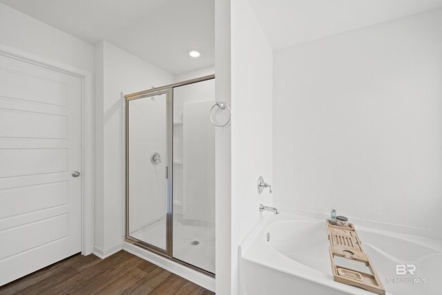 14705 Forsythia Loop, Silverhill, AL 36576 - full bathroom with a shower stall, a garden tub, and wood finished floors