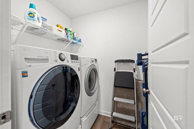 14705 Forsythia Loop, Silverhill, AL 36576 - washroom with washing machine and clothes dryer and dark wood-style flooring