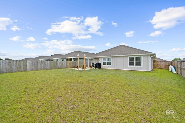 14705 Forsythia Loop, Silverhill, AL 36576 - rear view of house with a fenced backyard, a patio, and a shingled roof