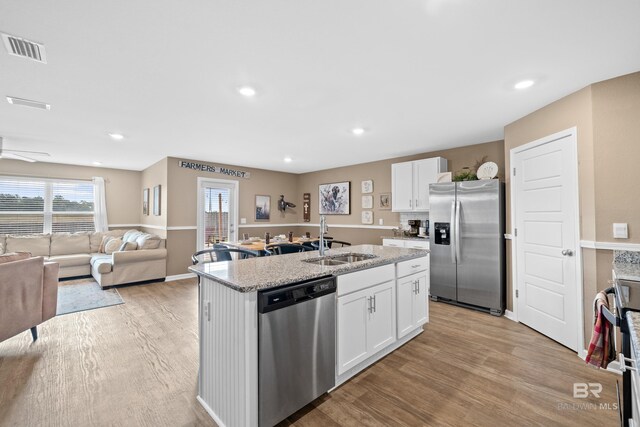 14705 Forsythia Loop, Silverhill, AL 36576 - kitchen with appliances with stainless steel finishes, an island with sink, light wood-style floors, white cabinets, and recessed lighting