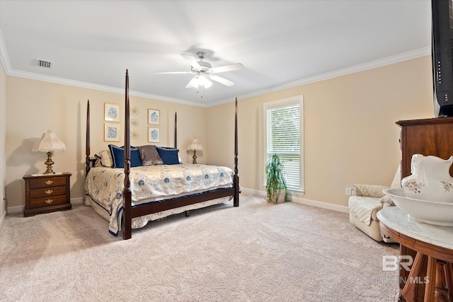 carpeted bedroom featuring ceiling fan, visible vents, baseboards, and ornamental molding