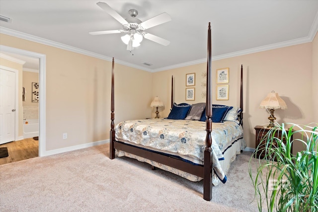 carpeted bedroom with a ceiling fan, baseboards, visible vents, ornamental molding, and ensuite bathroom