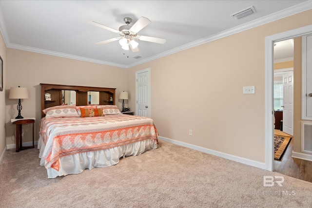 carpeted bedroom featuring visible vents, a ceiling fan, crown molding, and baseboards