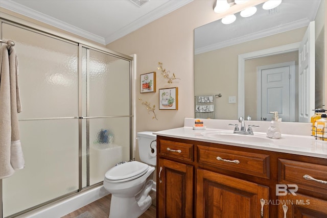 bathroom with a stall shower, toilet, crown molding, and vanity